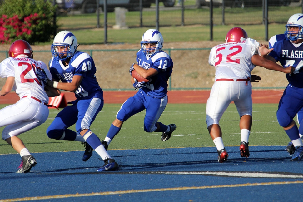 Trysten Riddle Carries the ball for a first down while he gets a block from 40 Alex-Vargas