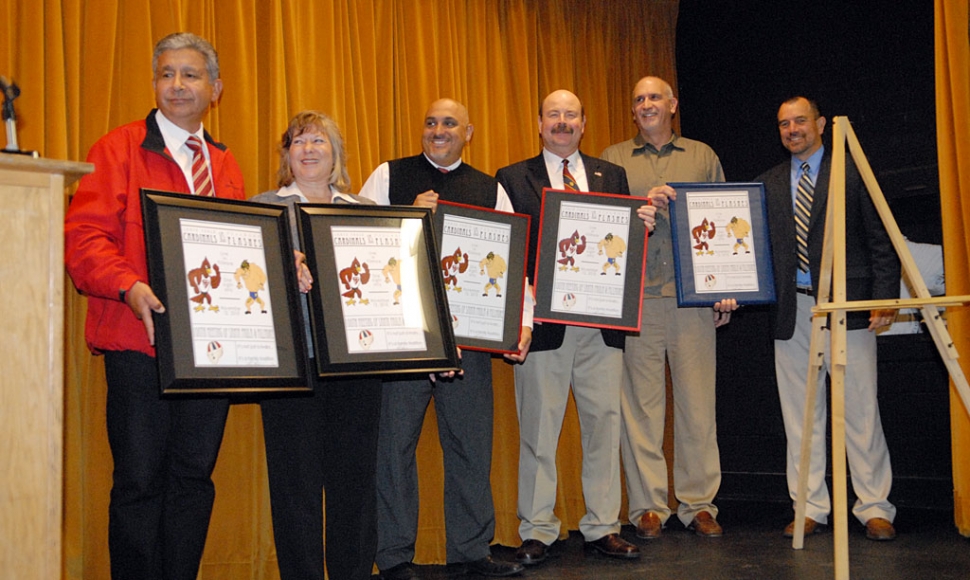 Fillmore Athletic Booster club President Andy Aguirre presented a poster drawn by 2010 Santa Paula graduate Alex Adams. (l-r) Santa Paula Mayor Jim Tovias, Fillmore Mayor Patty Walker, Santa Paula Principal Paul Marietti, County Superintendent of schools Stanley Mantooth, FUSD Superintendent Jeff Sweeney, and Fillmore principal John Wilber.