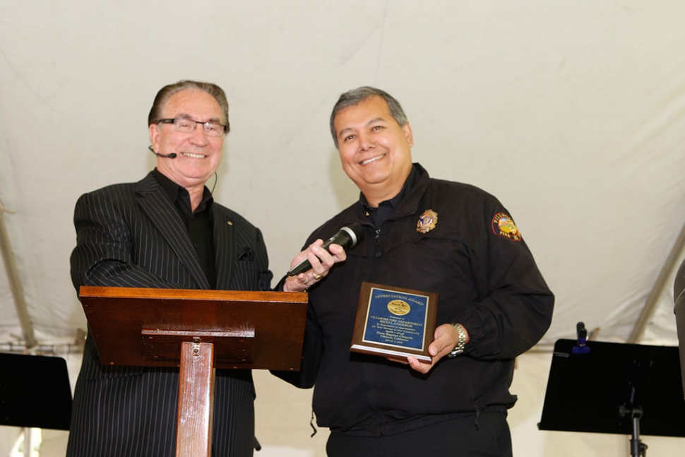 Fillmore Fire Chief Rigo Landeros is presented with an appreciation plaque by Pastor Golden.