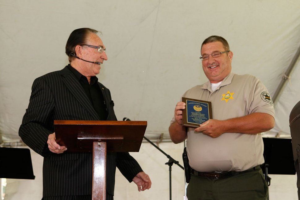 Fillmore First Baptist Pastor George Golden presents Fillmore Police Chief Dave Wareham with an appreciation plaque.