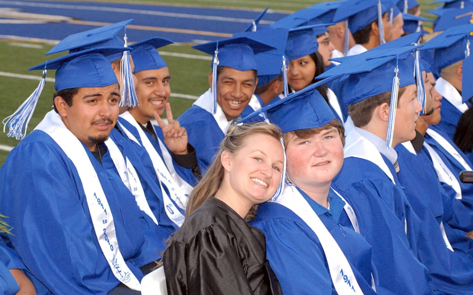 Several graduates patiently wait for their names to be called to receive their diplomas. Pictured front is Chelsea Dryer who accompanied her brother Jake to his graduation.