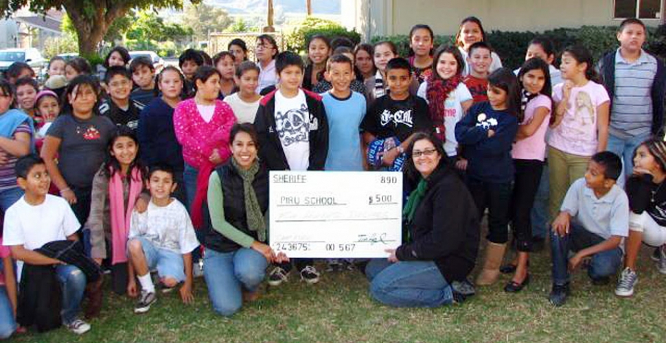 Pictured (l-r) are teacher Mrs. Delia Sliva and teacher Miss Claudia Cornejo and the 5th graders from Piru Elementary with a $500 check from the Ventura County Sheriffs for Friends of Fillmore Outdoor Education and Leadership Training. Ten more sponsors of $250 each are needed to send the entire class.