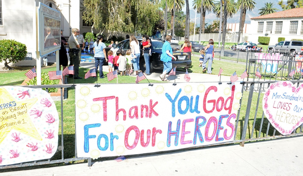 The children of Fillmore Christian Academy remembered the victims of 9/11 with banners and flags last Monday. Fillmore firefighters and sheriffs joined the memorial.