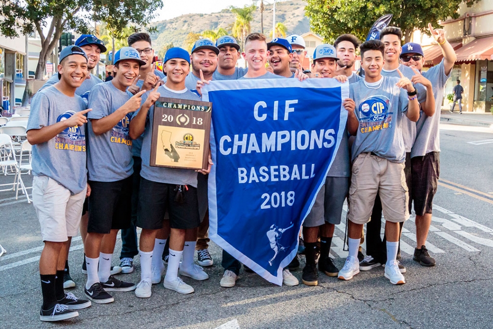 (above) The 2018 CIF Baseball Champions smile for a photo holding their banner and plaque. Fillmore High School held their Parade of Champions on Friday, July 6th at 6pm in downtown Fillmore to celebrate the CIF championships won by the baseball team and swimmer Katrionna Furness. People were able to hear the players and coaches speak, meet the team, and celebrate our champions. The players autographed complimentary 8x10 photos for the children. They had food trucks, vendors and entertainment for everyone to enjoy. Food Vendors: Fernandos Churros,  Amecis Pizza, Central Station Street Tacos, Raspado House, Nothing Bundt Cakes, Oh my gosh hot dogs. Parade line up: Police Chief Eric Tennessen, Cross Country, Heritage Valley Blazers, Fillmore Raiders, Girls Softball, Little League, Voltage Cheer, AYSO, Fillmore Bears, Girls Soccer CIF Champions, Kat Furness Swim CIF Champion, 1988 Baseball CIF Champions, and the 2018 Boys Baseball CIF Champions.Entertainment: Fillmore High School Ballet Folklorico, DJ Danny Ibarra. Photos courtesy Bob Crum.