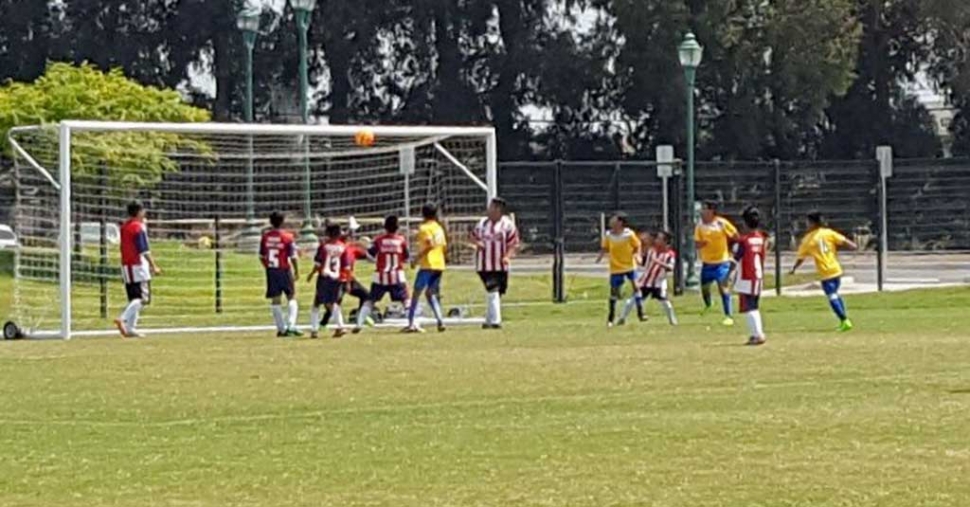 A touch and go play in front of the goalie in the U-12 game. Photo courtesy of Irma Espino.