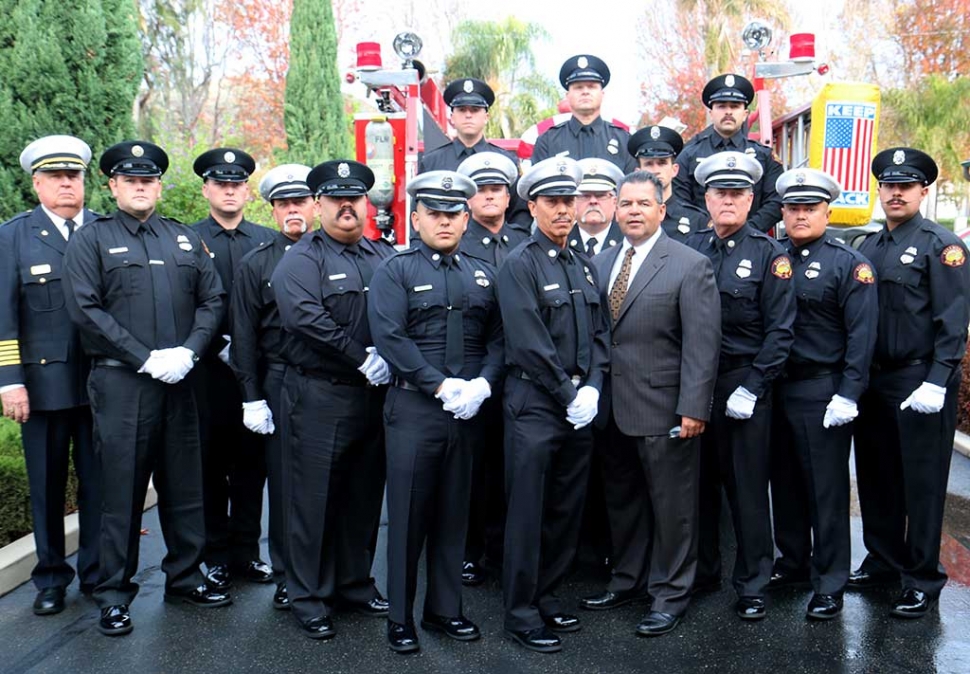Engine House 91 firefighters stand to honor Chief Rigo Landeros.