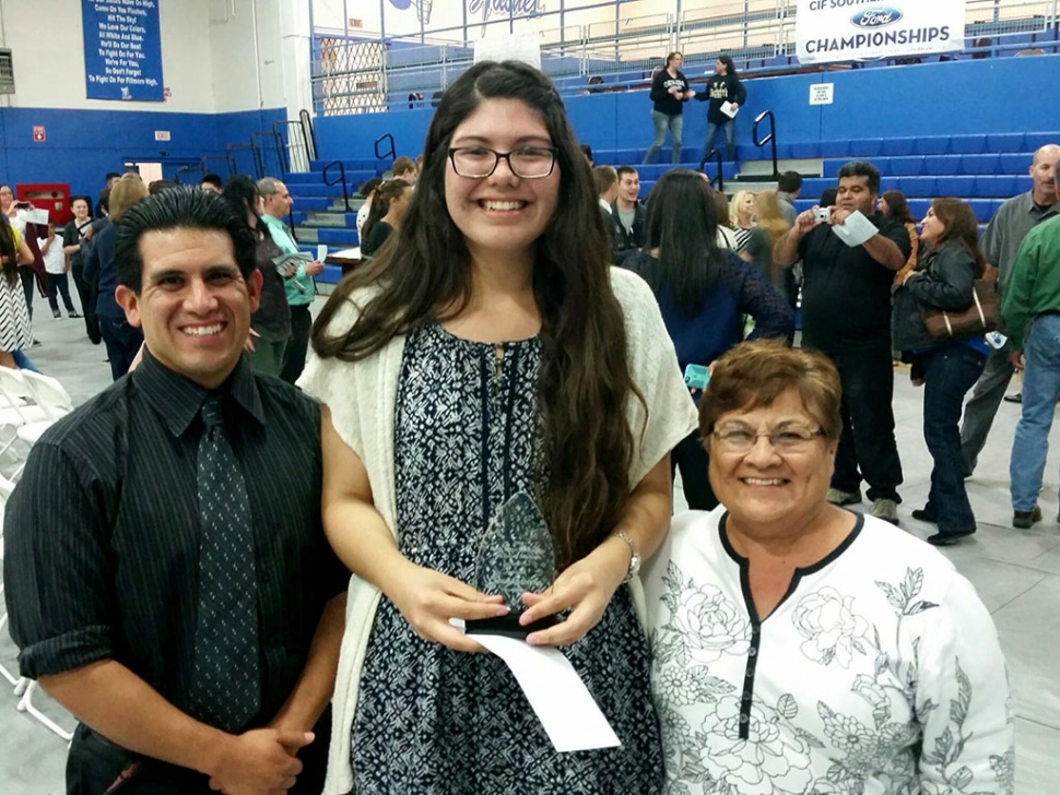 Fillmore High School graduating senior, Claudia Moreno (center) is the recipient of the 2015 Rosie Torres Scholarship For Future Teachers. Michael Torres (left) and Rosie Torres (right) recently presented the award at an on-campus ceremony.
