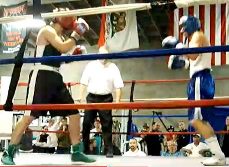 (above) Eric Figueroa wearing the black jersey and red gloves, squares off with his opponent. Fillmore Boxing Club's Eric Figueroa and Jonathan Minero competed at the Ventura KO Boxing Club's 