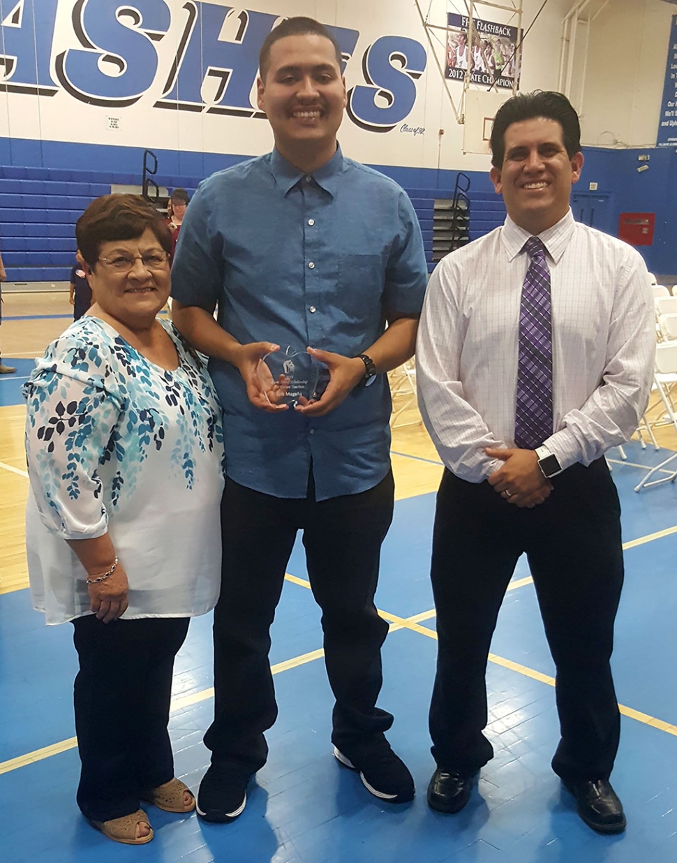 On May 29th, Fillmore High School Senior Erik Magana (center) was presented the Rosie Torres Scholarship for Future Teachers by both Rosie and Michael Torres at the campus awards ceremony. Photo courtesy Ralph Flores.