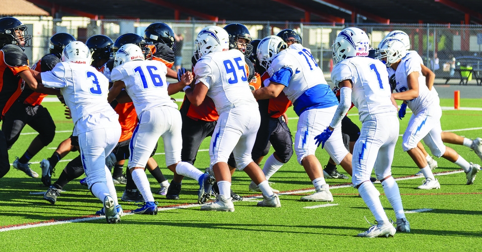 Pictured above is Flashes JV Offense trying to clear a path for a fellow teammate to break through the line. Photo credit Crystal Gurrola. 