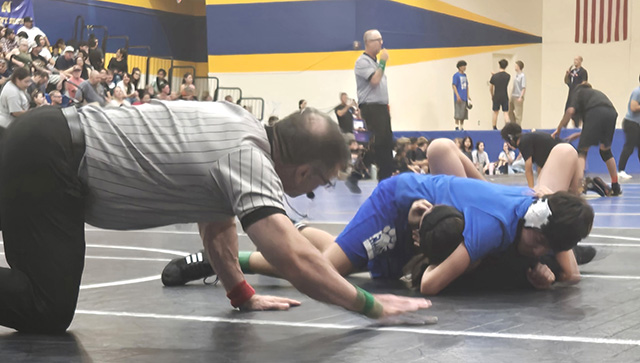 Above is the FMS Bulldog Christopher Padilla taking his opponent to the mat during his match on March 12. Photo credit Michael Torres & Cindy Vazquez.