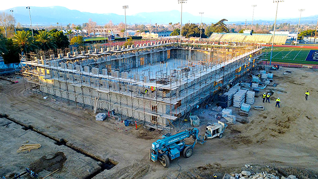 Above is the Athletic Complex surrounded by vertical scaffolding, with masonry/grouting work taking place on the 16-foot walls. The FHS Athletic Complex project’s anticipated completion date is February 2026.