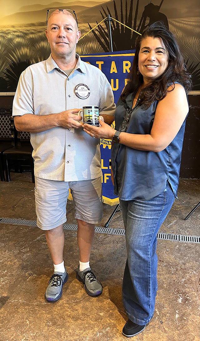 Rotary President-Elect John Meadows presents a commemorative mug to guest speaker Cinda Francis, principal of Fillmore High School. Photo credit Martha Richardson.