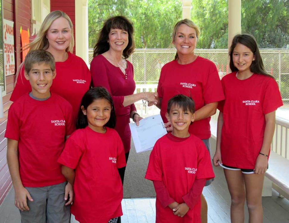 Leslie Klinchuch, Project Manager for Chevron for the Santa Clara Valley presents a check to the principal, Kari Skidmore for $4,000 to support the Music in the Classroom program.