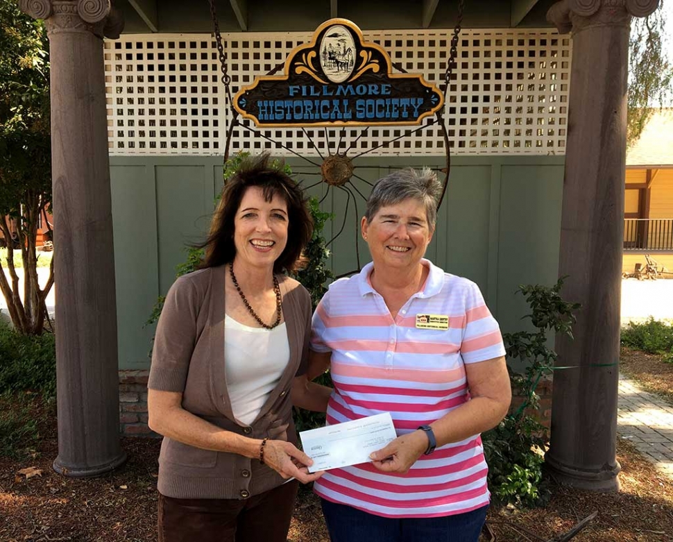 Chevron’s Leslie Klinchuch, left, presented Martha Gentry of the Fillmore Historical Museum with a $2,000 donation check for the March 2018 commemoration of the 90th anniversary of the St. Francis Dam disaster.