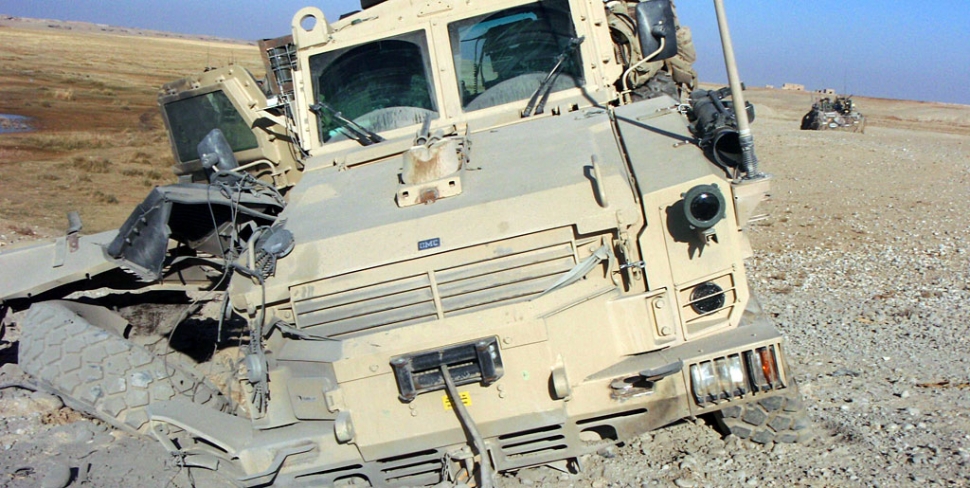 Above and below, a military truck damaged by a 152 mm artillary shell in Afghanistan.