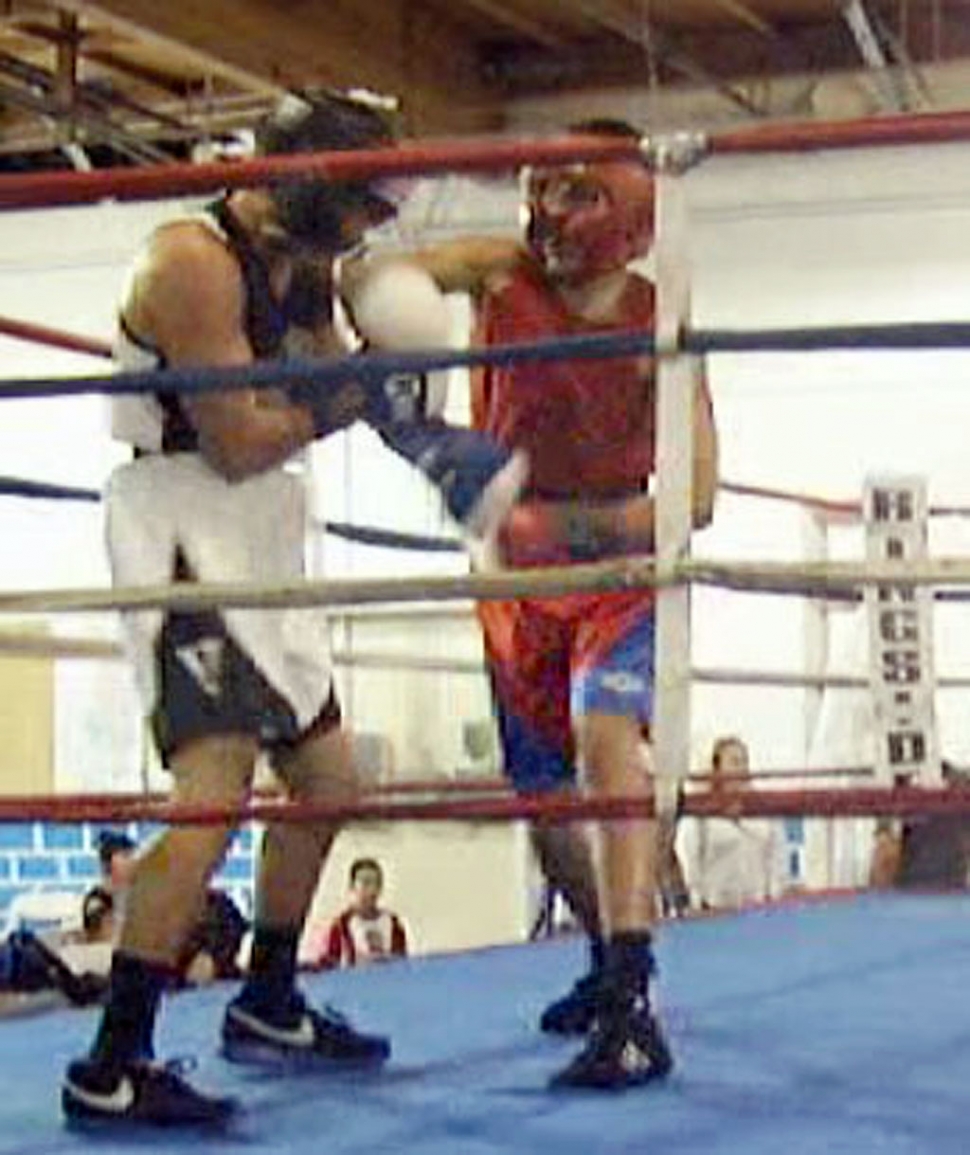 Jonathan (red jersey) lands a right cross on his opponent's jaw.
