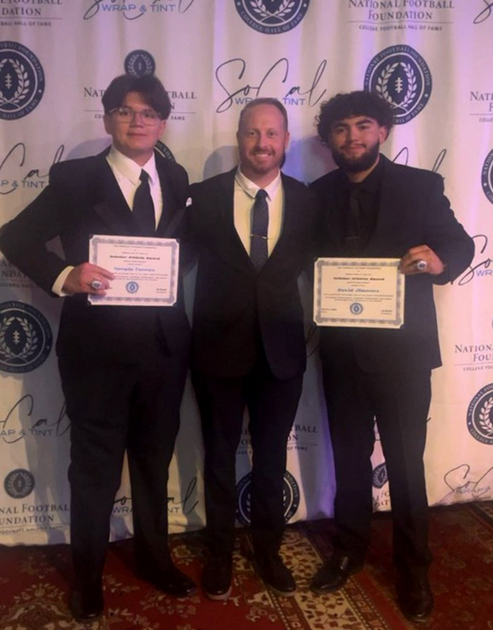 Pictured (l-r) are National Football Foundation Hall of Fame Inductee Sergio Torres, Fillmore High School Head Football Coach Charlie Weis, and National Football Foundation Hall of Fame Inductee David Jimenez. Photo courtesy Fillmore Unified School District Blog.