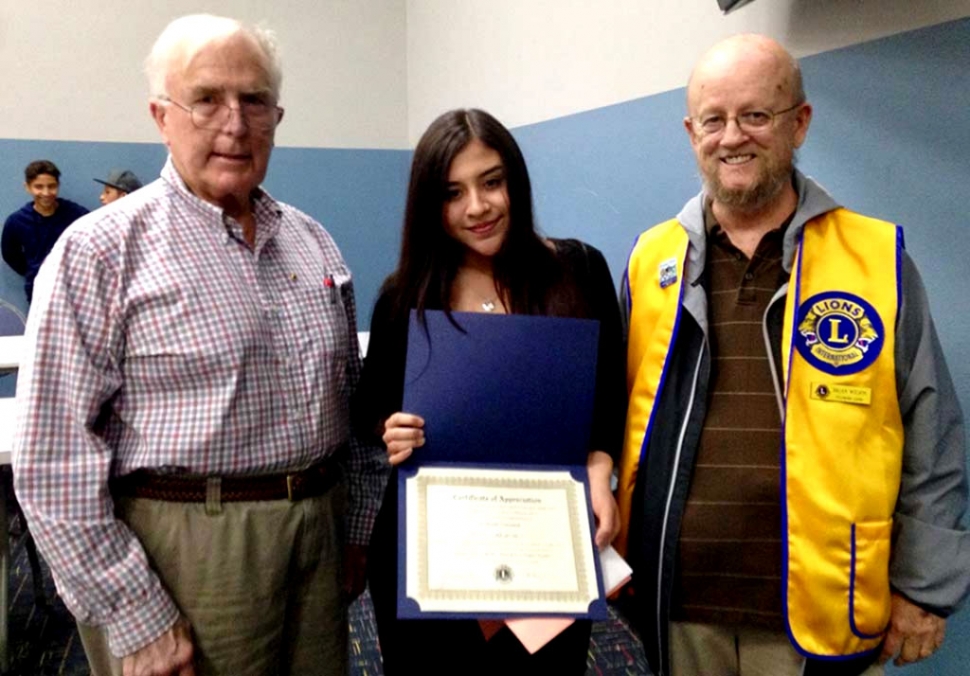Pictured are Lions Club members Bill Dewey (left) and Brian Wilson with last year’s Lions Club Student Speaker Contest winner Alina Herrera.