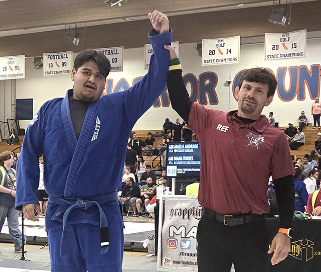 Pictured above is Diego Murillo raising his arm in victory during his match at the 2026 Grappling X West Coast Jiu-Jitsu Championships. Diego finished the tournament by claiming gold in the heavyweight blue belt intermediate division. Photo credit Michael Torres.