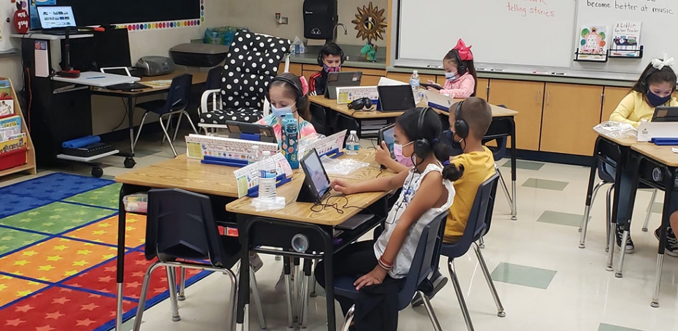 Pictured are a group of Wildcats, from Mrs. Gray’s 2nd Grade class at Mountain Vista, as they practice their reading skills using their iPads. Courtesy Mountain Vista Elementary School Website.