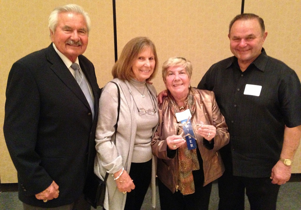 Nan Drake holds the Pacific Coast Business Times award. She is with (from l-r) Harrison Industries President Ralph Harrison, his wife Jenny and Harrison Vice President Jim Harrison.