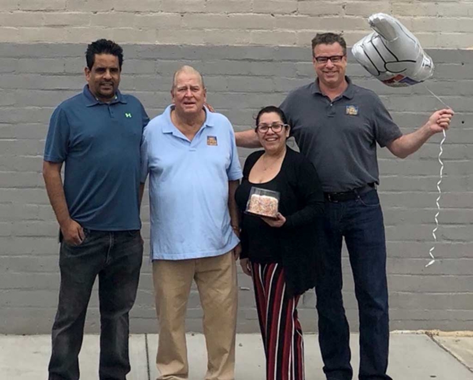 The Nova Storage Team, Ralph Jimenez, Larry Layne, Irma Magana and Andrew Rankin, smile for a photo after receiving the 2017 Business of the Year Award by the Fillmore Chamber of Commerce. Courtesy Ari Larson.