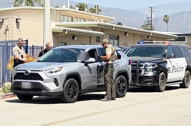U.S. Immigration and Customs Enforcement (ICE) agents were parked at the Fillmore Sheriff’s station on Tuesday after being followed aggressively by a female driver on Highway 126, including the use of a PA system installed in her car. The woman is shown parked behind the federal agents’ car; inset, agents speaking with the female driver. Two weeks ago, a woman who identified with VC Defensa followed and harassed a private citizen, believing he was ICE. The incident was reported to the Fillmore Police Department.  A witness to the incident said the woman also identified herself with VC Defensa. False “sightings” of agents have also been posted on Facebook, when Sheriff Deputies serving warrants/probation searches are observed. Photo credit Sebastian Ramirez.