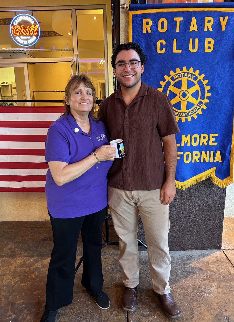 Pictured is Rotary Club of Fillmore President Anna Reilley presenting program speaker Jared Schieferle 
with a Rotary mug. Photo credit Martha Richardson.
