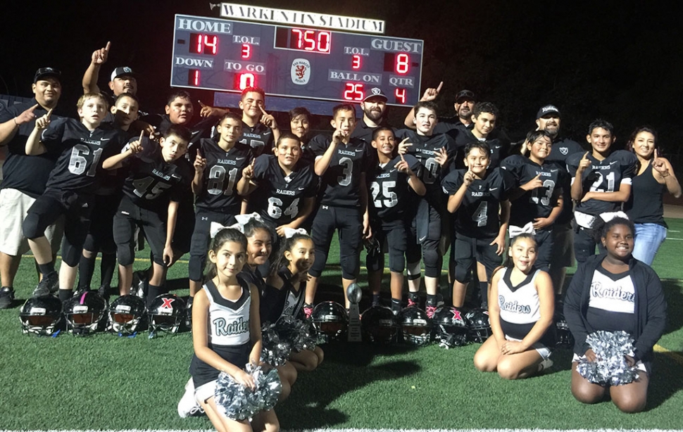 This Past weekend the Fillmore Raiders Juniors Division won the Gold Coast Youth Football League American Conference title against the Santa Paula Cardinals with a final score of 14 – 8. Coaches Danny and Brock Nunez led the boys to a 9 – 1 season and a Championship Title. Picture l-r Freeman Hicks, Dylan Swetman, Joseph Cervantes, Daniel Viveros, Nate Torres, David Jimenez, Isaac Murphy, Jacob Navarro, David Negrete, Oscar Navarro, William Frost, Christian Peña, Martin Rodriguez, Juan Suarez, Nick Guerra Back Row Coaching staff: Gabe Gomez, Fidel Viveros, Brock Nunez, Pete Torres, Danny Nunez, Mom Rupa Torres Coaches. Not pictured: Bryce Nunez and Jake Saviors. Photo courtesy Rupa Torres.