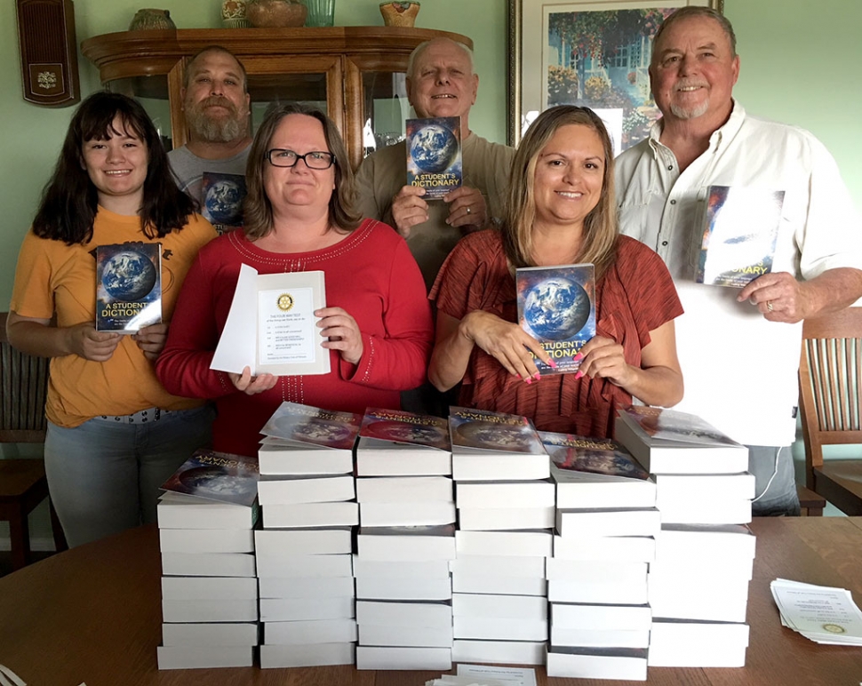 Fillmore Rotary Club prepares for their Literacy Project. Dictionaries will be distributed to every 3rd grader in the Fillmore Unified School District this coming September. Members and friends gathered to place Rotary labels, with the 4-Way Test inside each book. Pictured above are some of the Rotary members who helped with placing labels. Back row l-r: Lynn Hicks, Dick Richardson, Dave Andersen Front Row: Soleil Peacock, Alicia Hicks, and Ari Larson. Photo courtesy Martha Richardson.