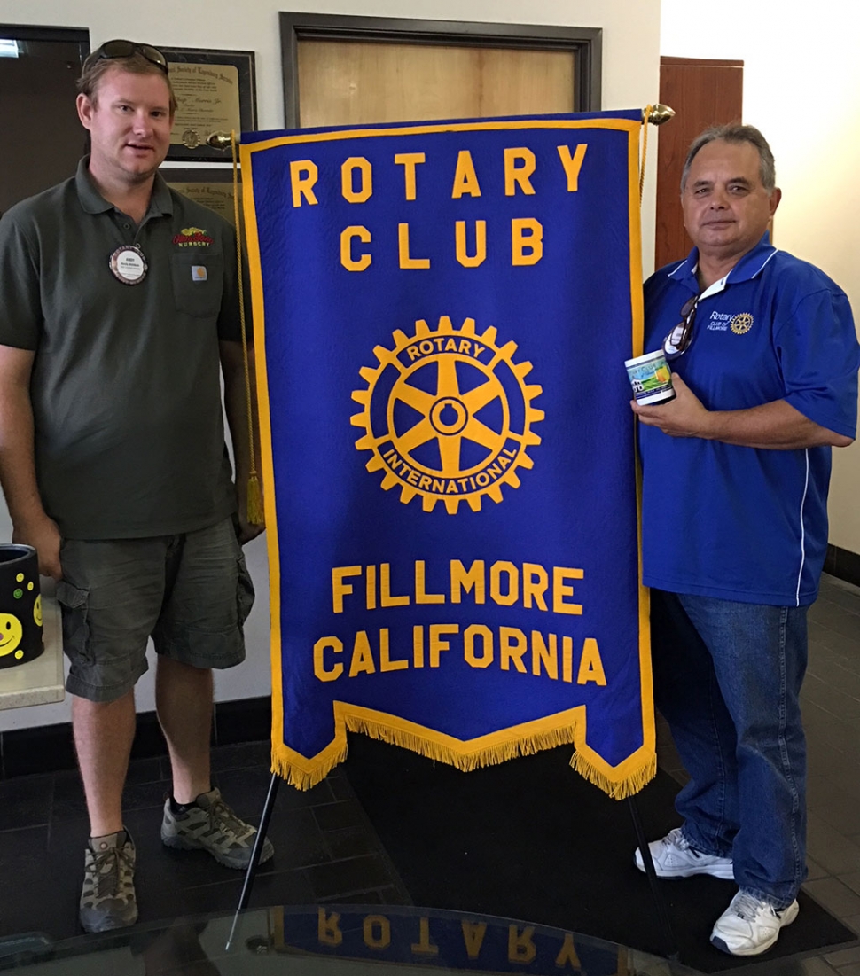 (l-r) Rotary Club President Andy Klittich presenting Ernie Villegas with a mug to recognize all the time he has dedication he has put into the Designation Fillmore program. Photo courtesy Martha Richardson.