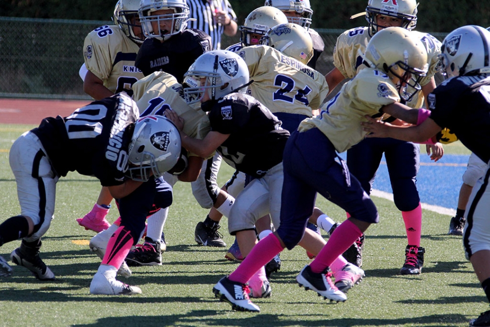 Raiders Bantam Black #00 and #32 make and first down saving tackle