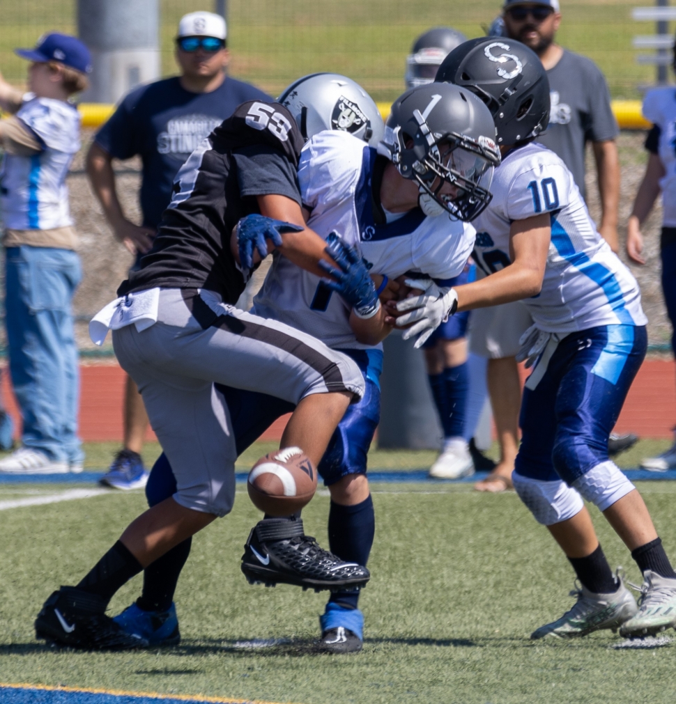 Raiders Junior #53 making a tackle and knocking the Camarillo Blue player’s hands during last Saturday’s game. Photo credit Crystal Gurrola
