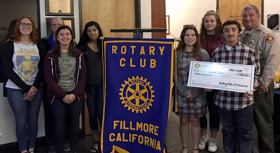 Fillmore Rotary Club donated $500 to the Fillmore High School Swim Team. Pictured are six team members along with their coach Cindy Blatt, accepting the donation from Rotary President Dave Wareham. Photo courtesy Martha Richardson.
