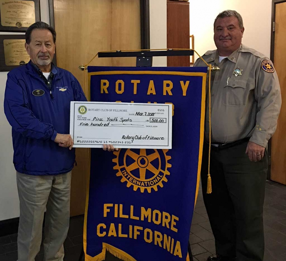 Pictured left is Gilbert Escoto who has been instrumental in establishing Piru Youth Sports, accepting a $500 check for the program from Fillmore Rotary Club president Dave Wareham. Photo Courtesy Martha Richardson.