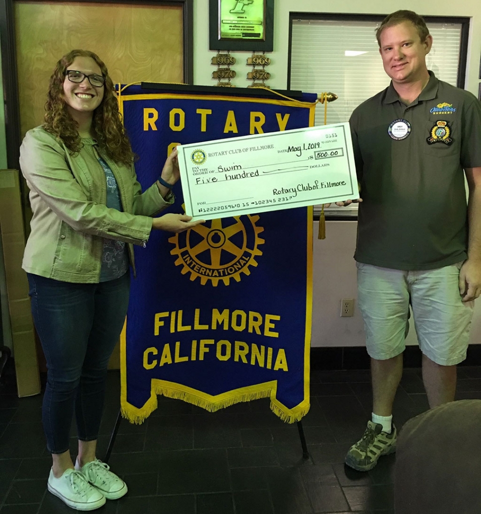 Pictured is Isabella Palazuelos accepting a donation check of $500 from Rotary President Andy Klittich, for the Fillmore High School swim program. Photo courtesy Martha Richardson.
