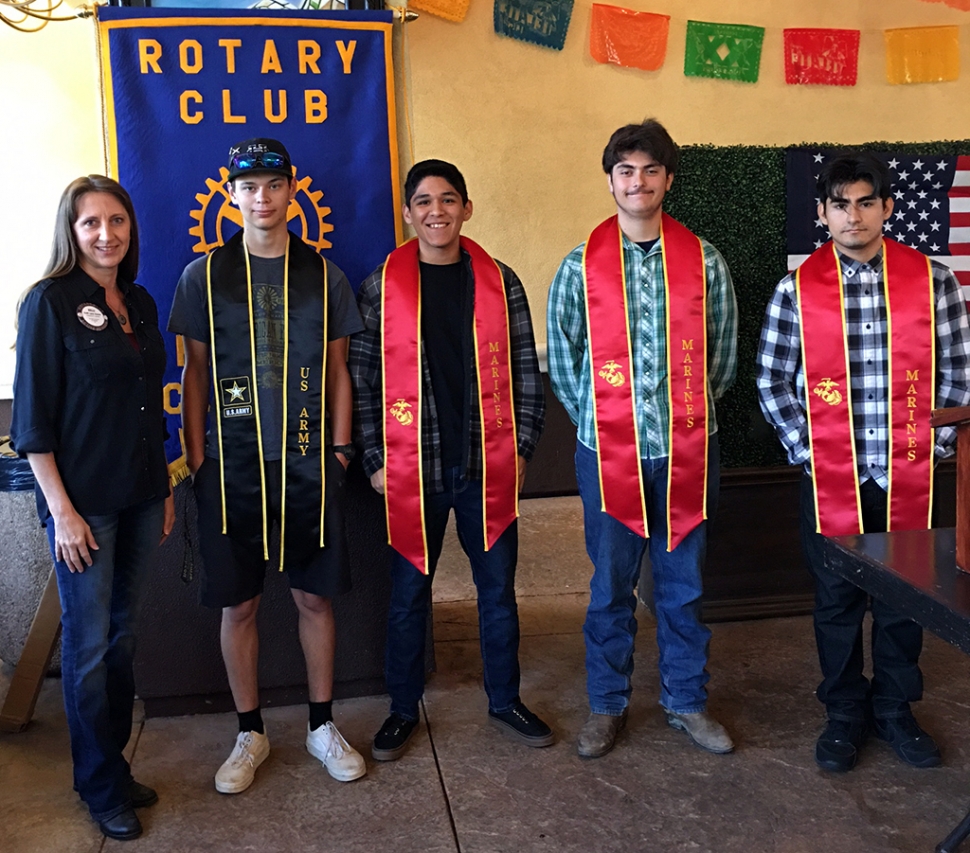 Rotarian Kelli Couse (left) grew up in a military family and because of this she believed the FHS students who decided to join the military, instead of attending college, needed to be recognized. For several years she has presented these students with a special sash, with their branch of the Military, that they can wear at graduation. Starting this year, the Rotary Club of Fillmore has become part of this recognition. Four students and their parents attended the club meeting last week, and were recognized, (l-r) Jordan Pillado-Army, Christian Juarez-Marines, Anthony Ownbey-Marines, and Cristian Cortez-Marines. Photo credit Rotarian Martha Richardson.