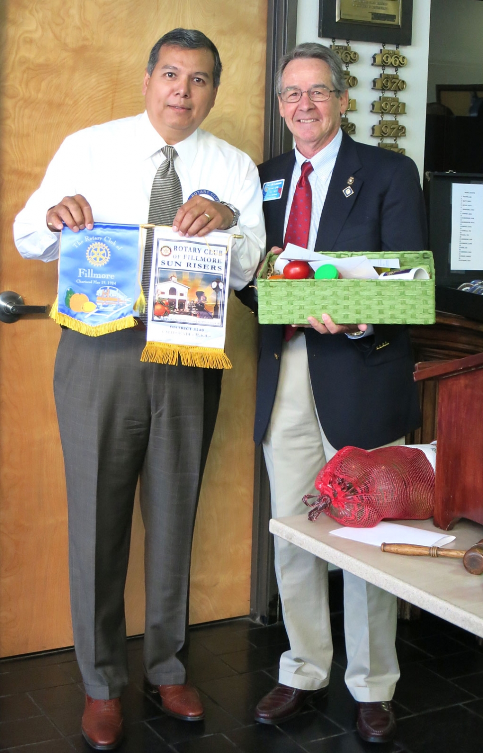 Rigo Landeros, Rotary Club President, presented District Governor Jack McClenahan with the club banners and a basket of locally grown produce.