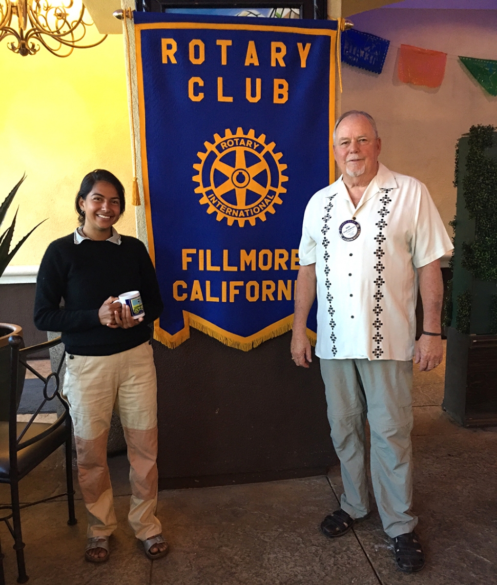 (l-r) Shanti Sandosham receiving a Fillmore Rotary mug from club President Dave Andersen. Photo Credit Rotarian Martha Richardson.