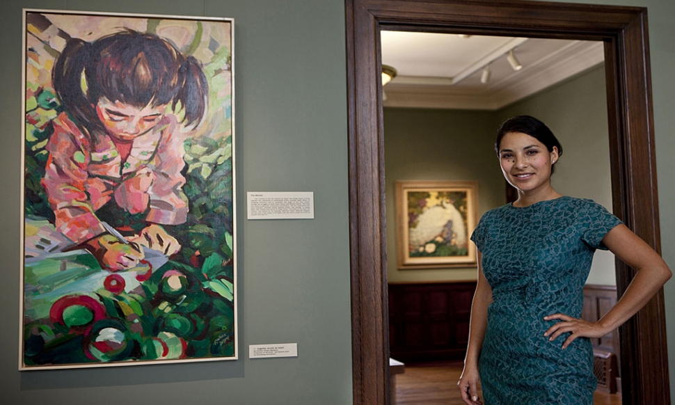 Andrea Vargas and her painting "Angelita", acrylic on wood.