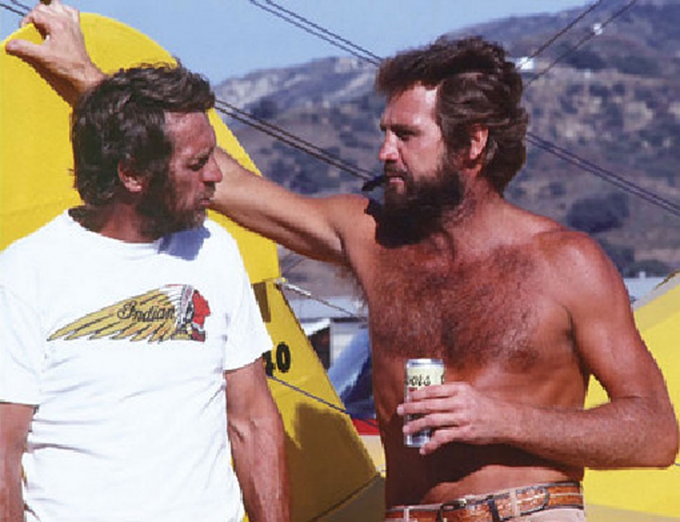 Steve McQueen and actor Lee Majors share a beer at the Santa Paula Airport, May 1979.