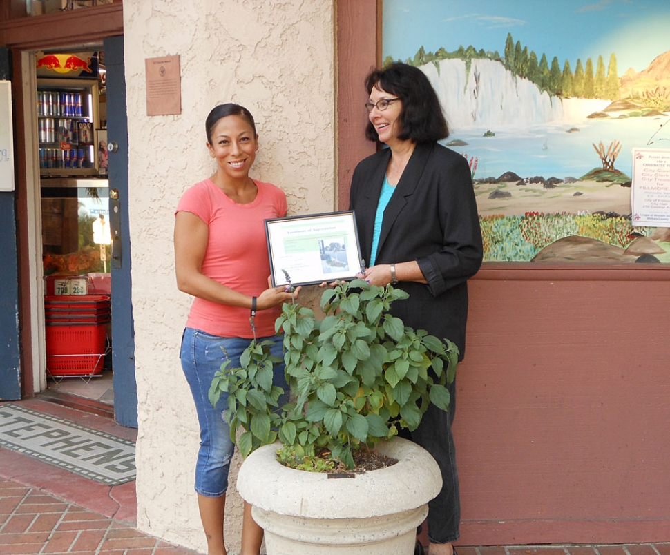 (l-r) Tanya Melgoza of Estrella Market receiving a certificate of appreciation from Civic Pride Committee member, Linda Nunes, for their sponsorship of a replanted pot on Central Avenue.