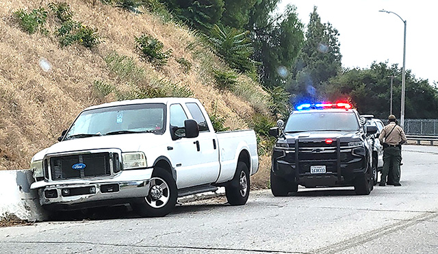 On Saturday, May 16, at 9:42 a.m., a white Ford pick-up truck hit a median on A Street. Cause of the crash is still under investigation for a possible DUI. Photo credit Marcus Camp.