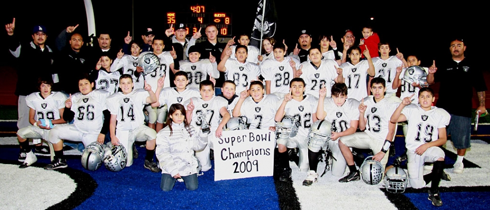 Congratulations to Fillmore’s J-2’s Raiders football team. They won the Super Bowl this past Saturday. Pictured above are the J-2 Raiders football players: Vincent Vargas, Ramiro Garcia, Aaron Cronin, Ryan Riberdy, Bakari Cook, Tyler Esquivel, Torey Negrete, Alex Tovar, Adam Jimenez, Deangelo Castro, Brendan Aguilar, Sonny Vigil, Ivan Hurtado, Eddie Cardenas, Michael Castro, Val Pillado, Johnny Chaveste, Steven Chaveste, Sammy Holladay, Nathan Martinez, Ernie Rangel, Joe Gonzalez, and Omar Valdivia. Coaches: Timmy Pillado, David Esquivel, Joseph Aguilar, Vince Vigil, Ram Medina, Cameron Bennett, Matt Chaveste, Val Pillado, and Larry Tovar Jr. Photo courtesy of KSSP Photographic Studios-Fillmore.