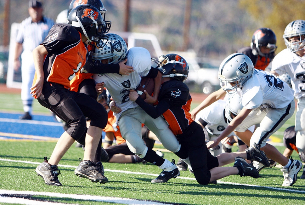 A J-1 Raiders football player keeps going to gain yards last Saturday afternoon.