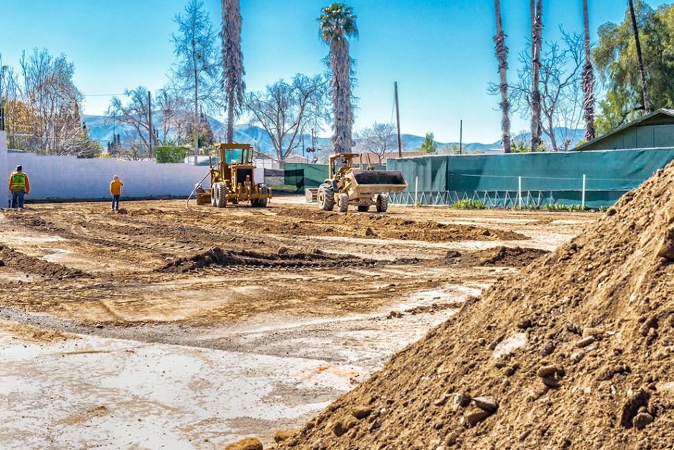 Earth moving machines preparing the lower RV lot for paving.