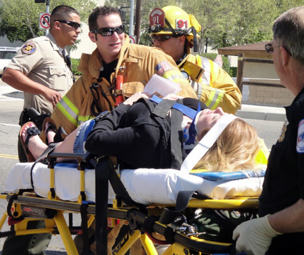 Collision victim is strapped onto gurney for transportation to Santa Paula Hospital.