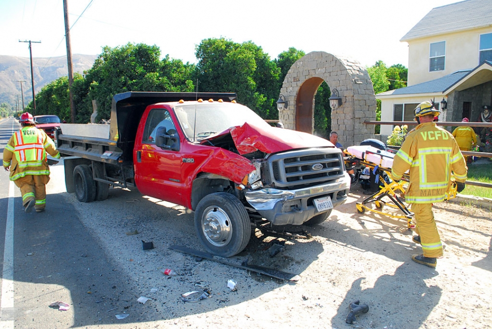 The adult male driver of the car was taken by ambulance to a local hospital for observation. The force of the impacts destroyed a heavy steel barrier and some signage. Extensive damage was done to all three vehicles.