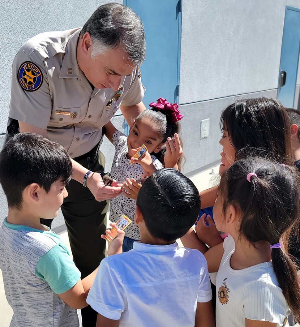 Fillmore Captain Garo Kuredjian spending time with Mountain Vista Elementary students as part of the Adopt-A-Cop program which is being brought back to Fillmore Unified School District. Photo courtesy Mountain Vista Elementary blog. 
